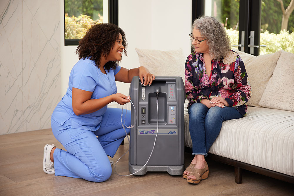 Oxygen Black Female Clinician White Female Sitting on Couch Oxygen Concentrator Airsep 10LPM 3
