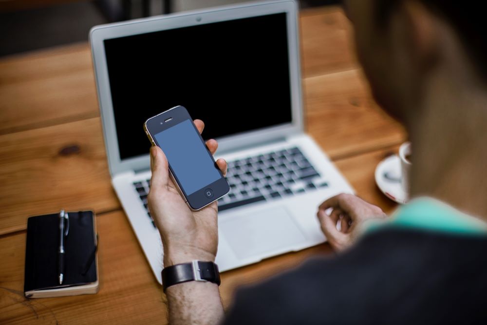 man on phone and laptop