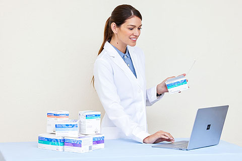 Female Pharmacist with Laptop and Unit Dose Medications like Albuterol